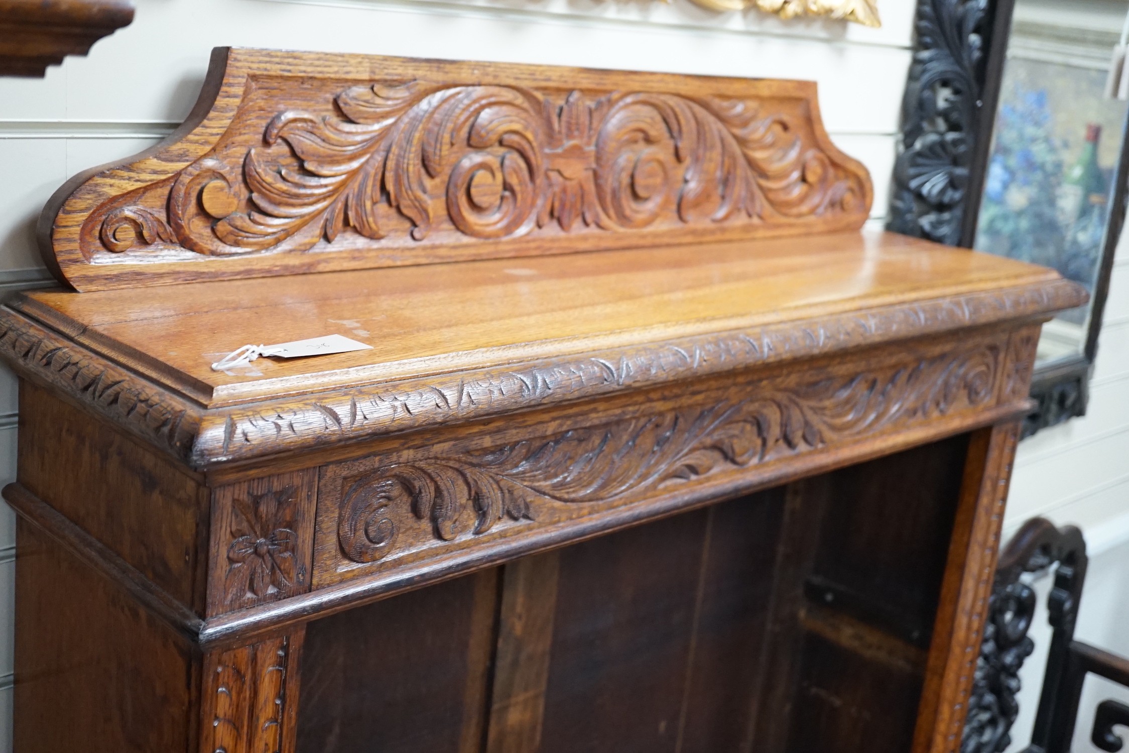 A late Victorian carved oak open bookcase, width 106cm *Please note the sale commences at 9am.